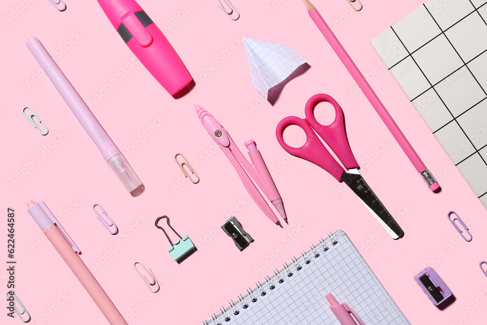 Set of different school stationery on pink background