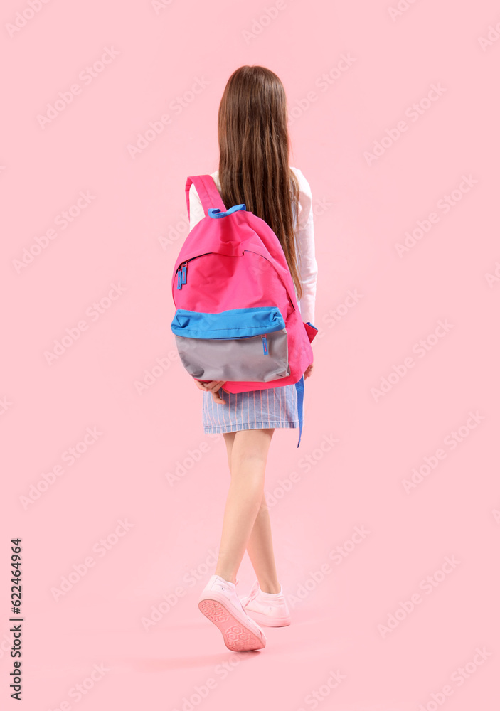 Little girl with schoolbag on pink background, back view