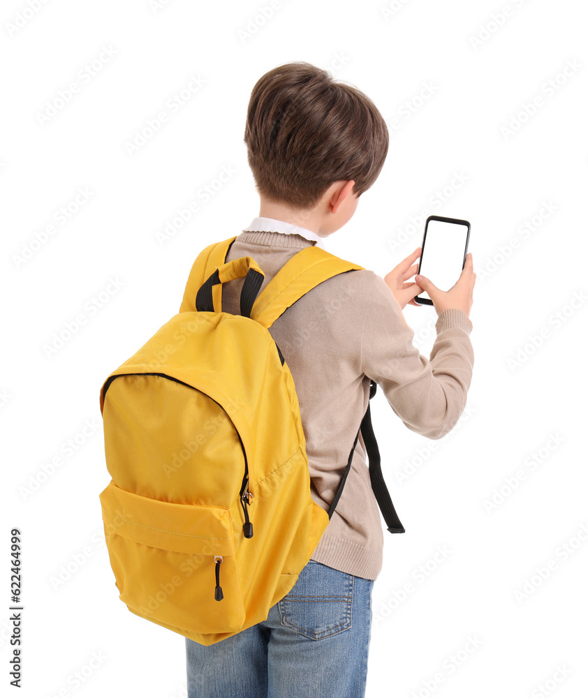 Little boy with schoolbag and mobile phone on white background