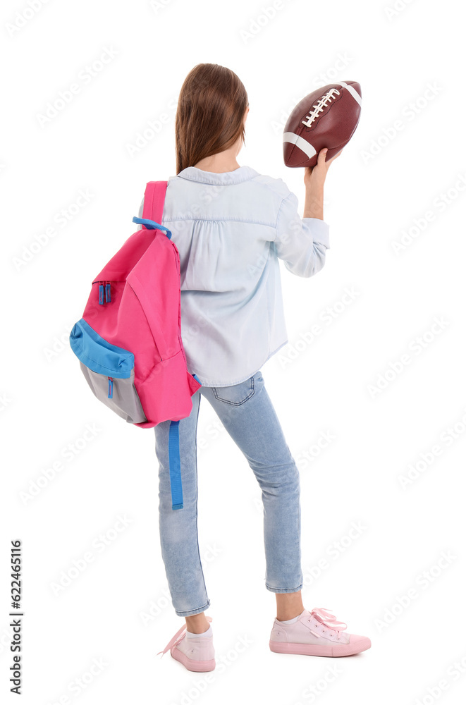 Little girl with schoolbag and rugby ball on white background, back view