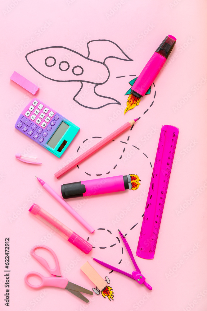 Creative composition with drawn rocket and different stationery on pink background