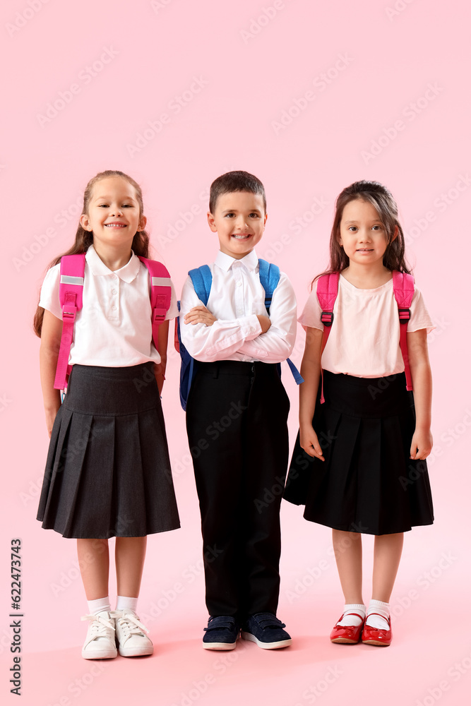 Little schoolchildren on pink background