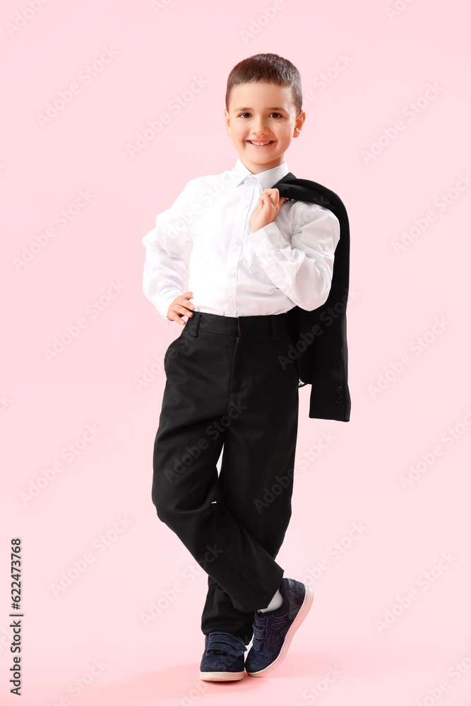 Little schoolboy on pink background