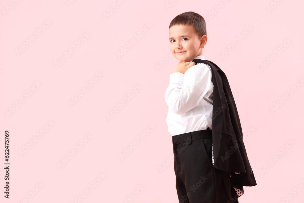 Little schoolboy on pink background