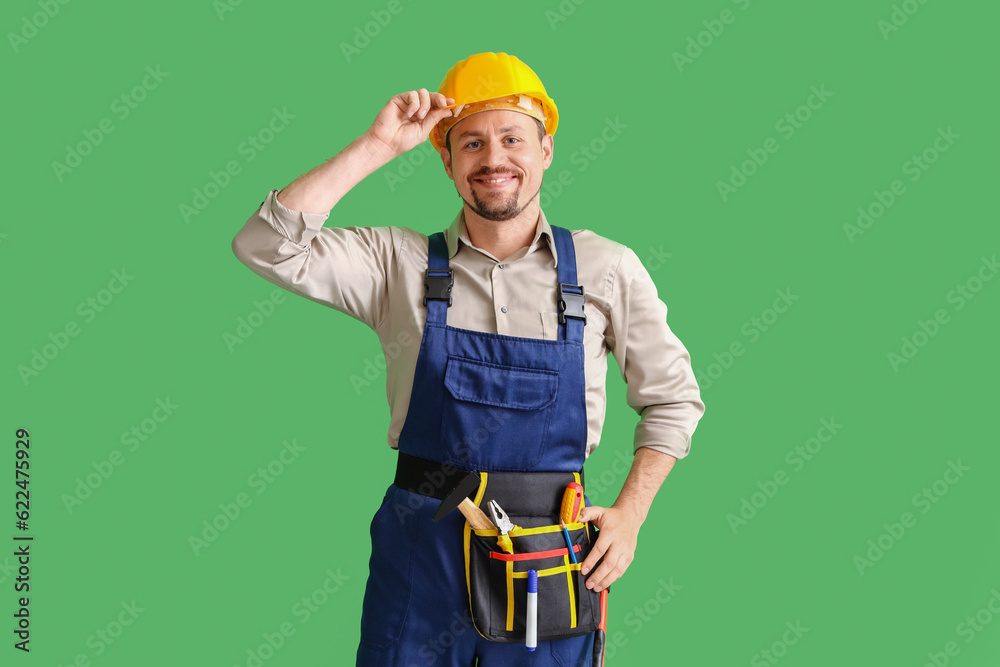 Male builder on green background