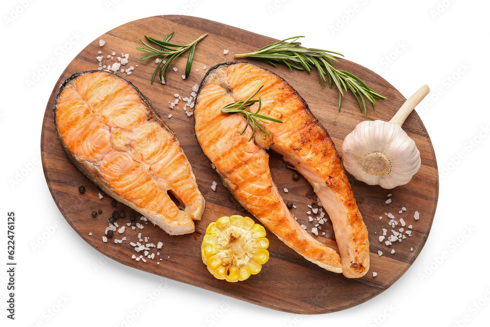 Wooden board with tasty grilled salmon steaks on white background