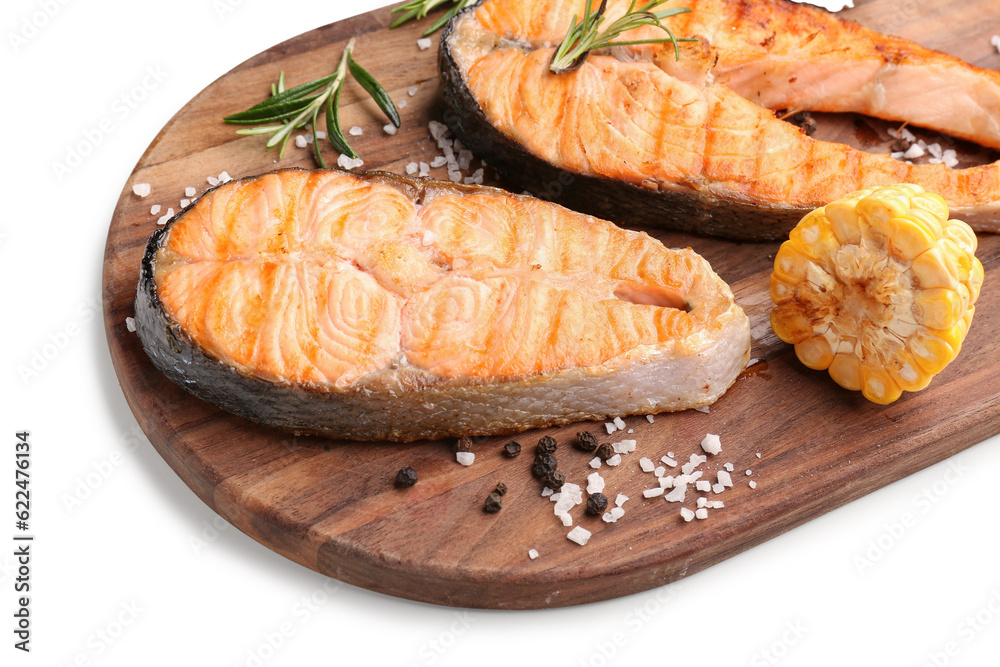 Wooden board with tasty grilled salmon steaks on white background