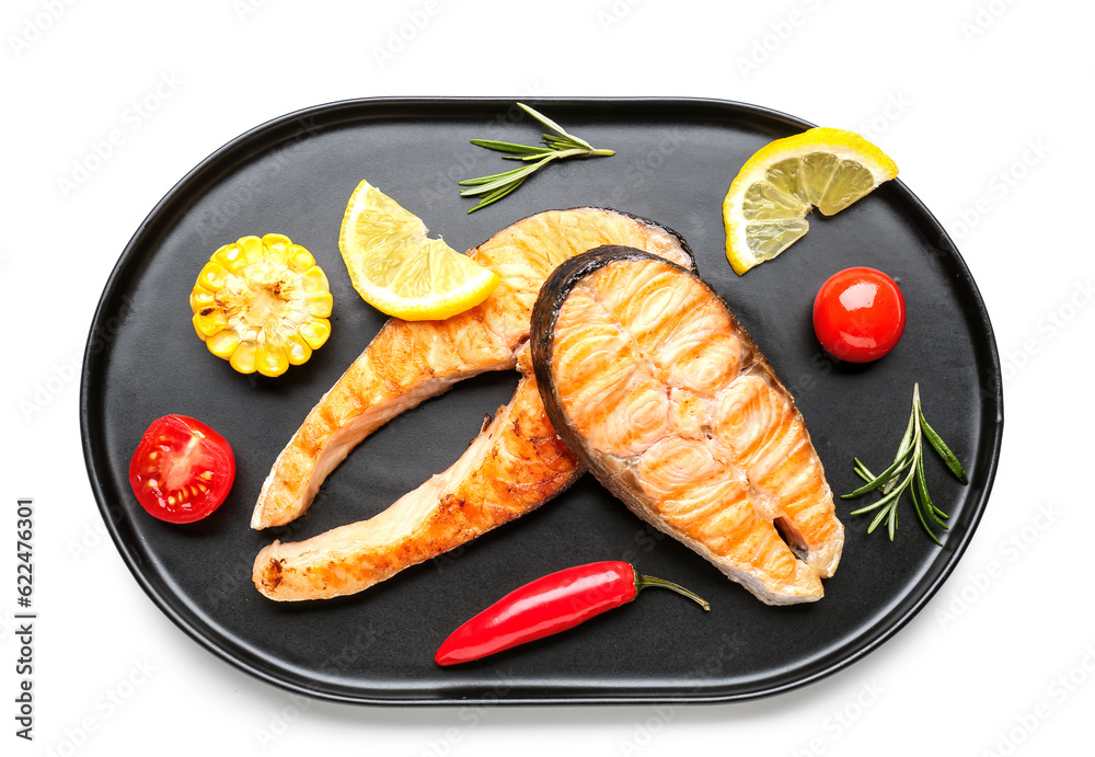 Tray with tasty grilled salmon steaks on white background