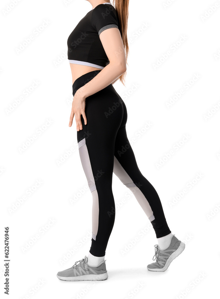 Young woman in sportswear on white background