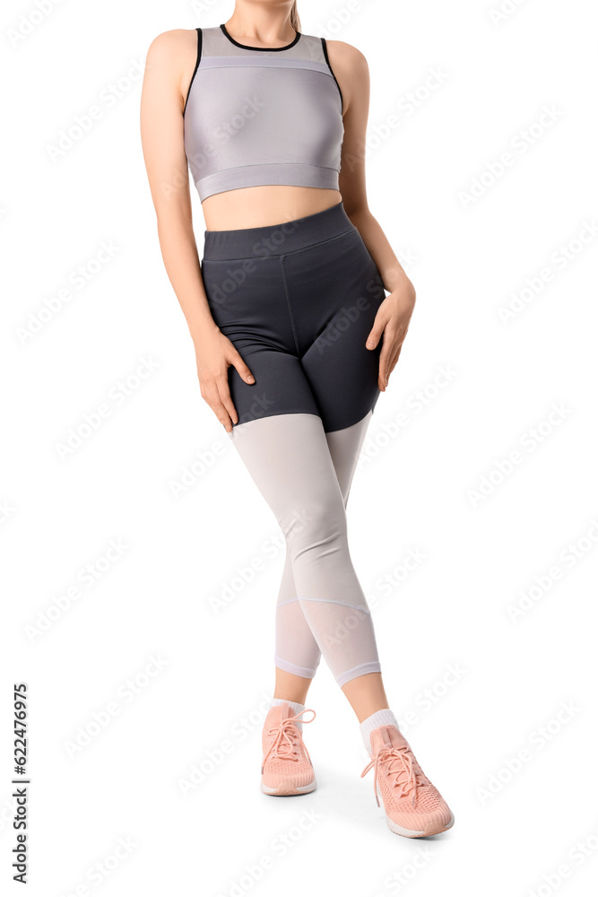 Young woman in sportswear on white background