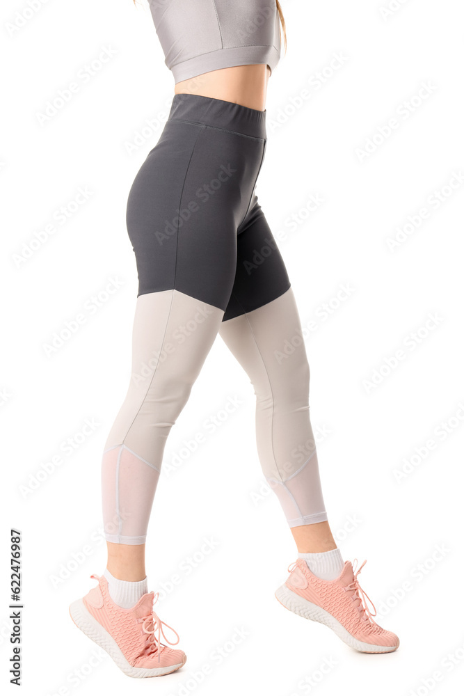 Sporty young woman in leggings on  white background