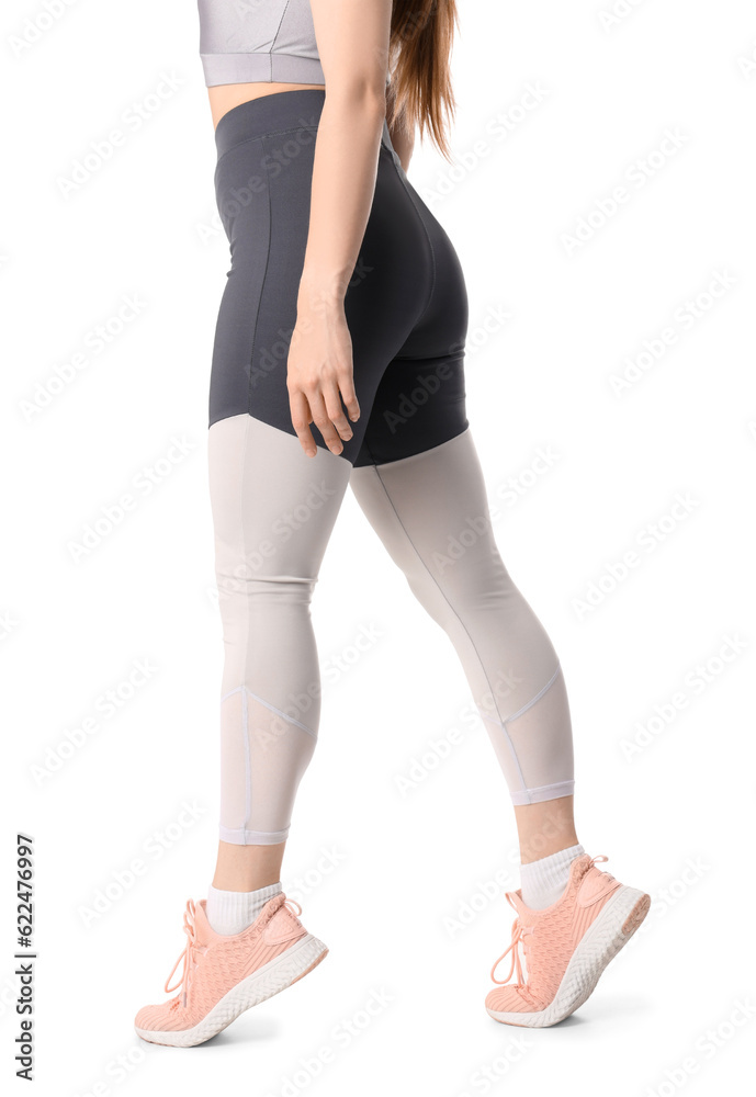 Sporty young woman in leggings on  white background