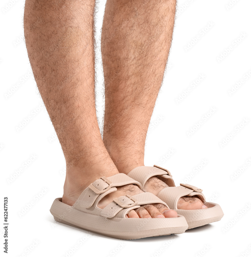 Male legs in flip-flops on white background