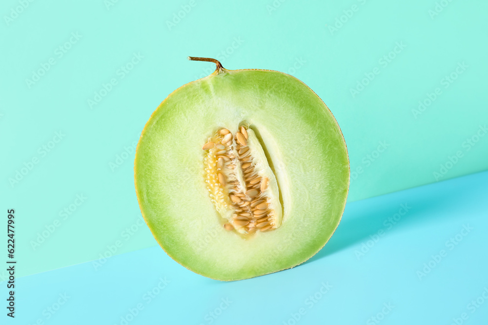 Half of sweet melon on blue background