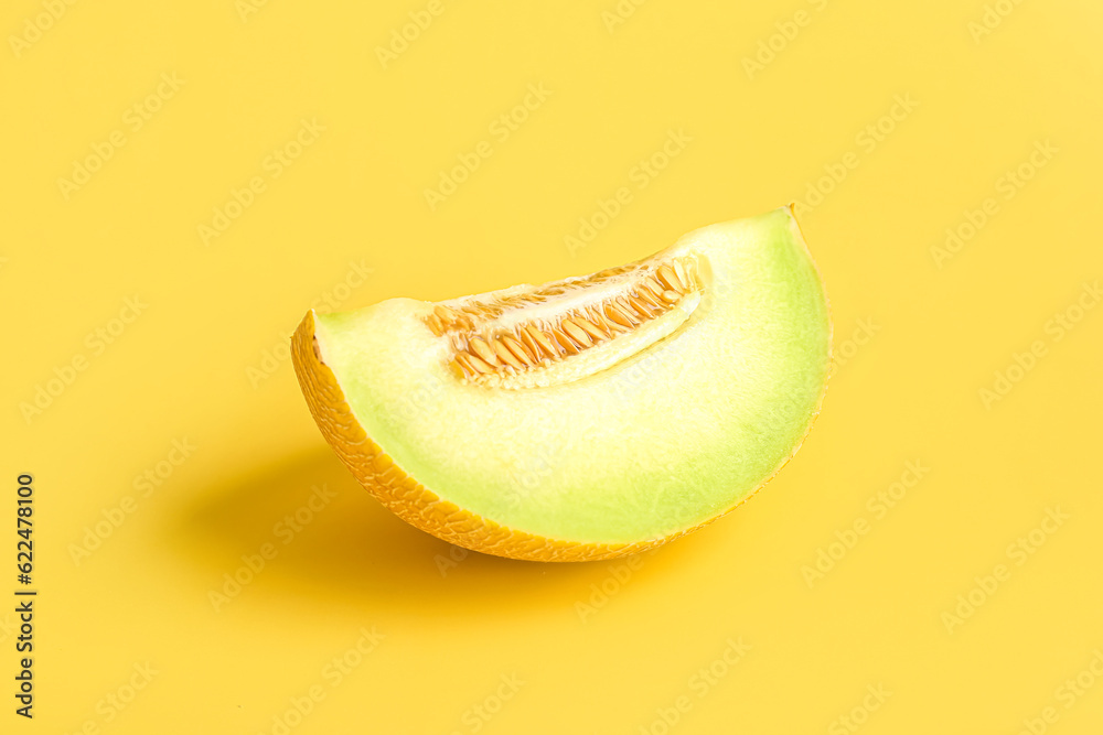 Piece of sweet melon on yellow background