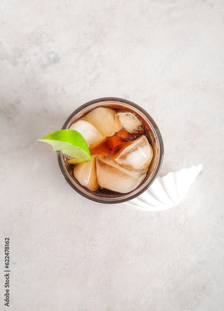 Glass of cold Cuba Libre cocktail on white background