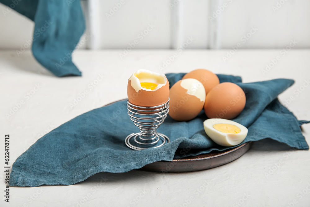 Plate with boiled chicken eggs on white background