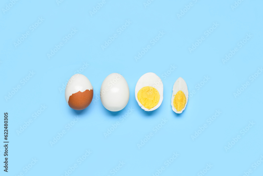 Tasty boiled eggs on blue background