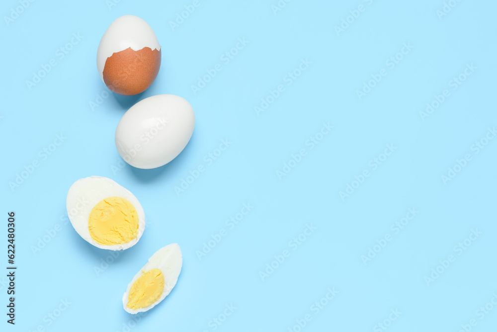 Tasty boiled eggs on blue background