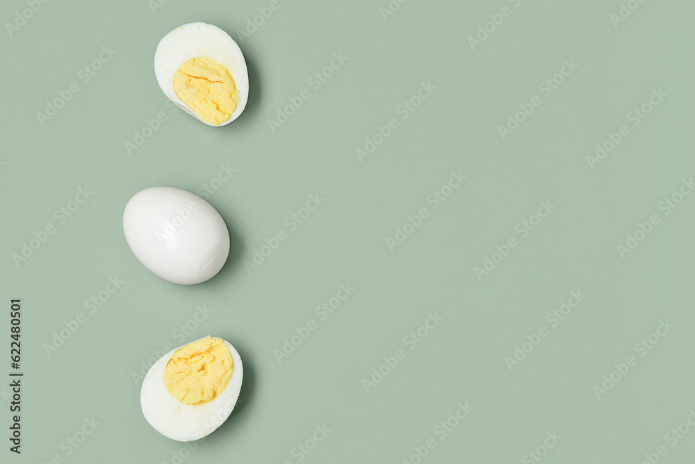 Tasty boiled eggs with half on grey background