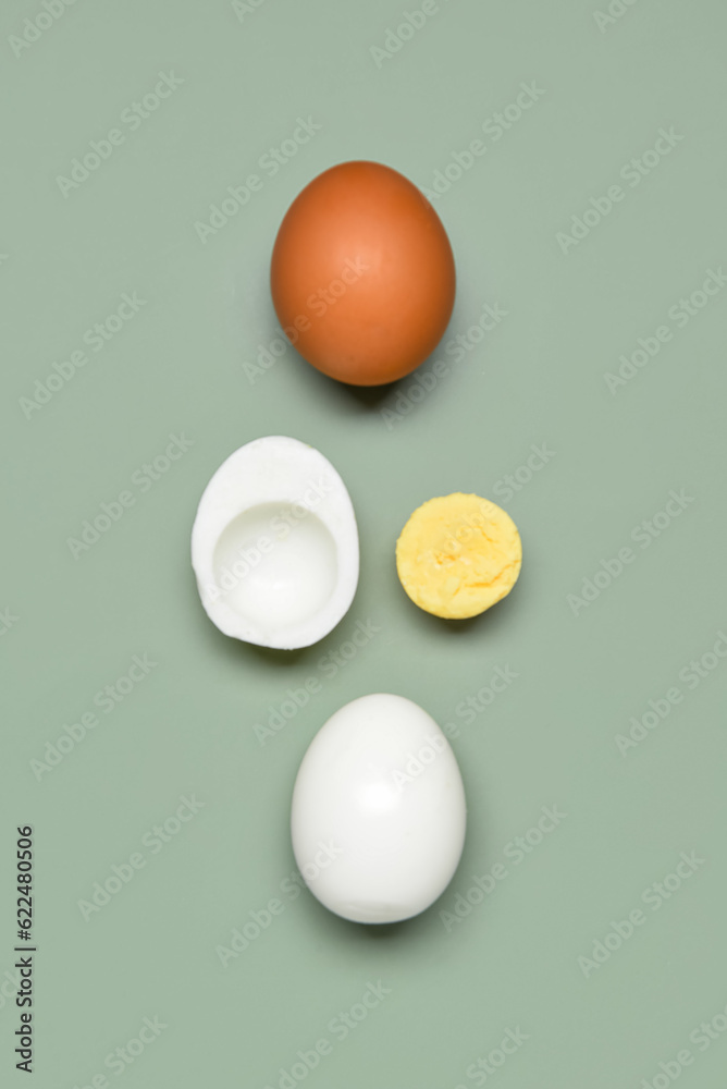 Tasty boiled eggs with half on grey background