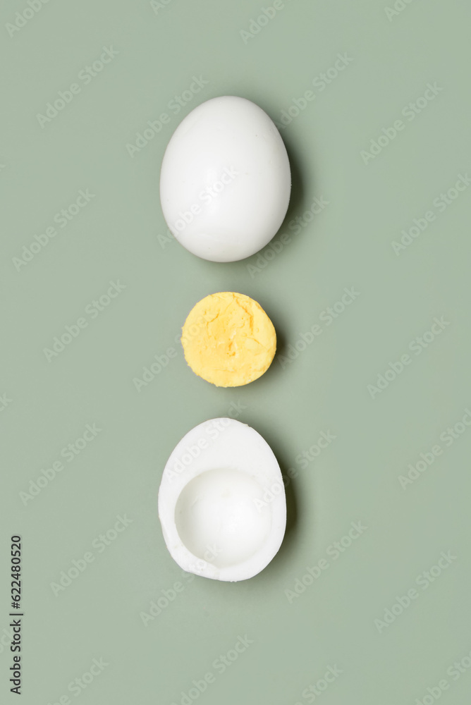 Tasty boiled egg with half on grey background