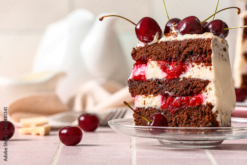 Plate with piece of tasty cherry cake on table