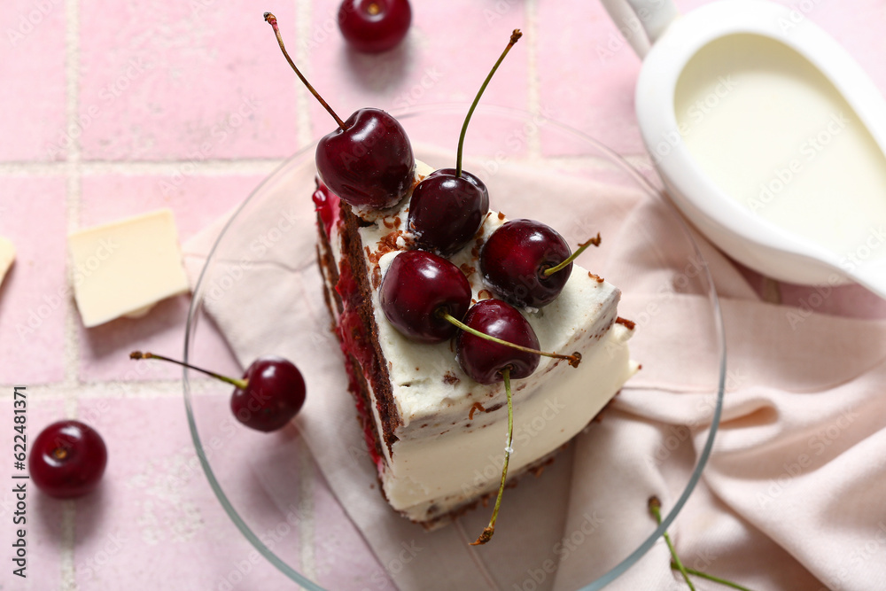 Plate with piece of tasty cherry cake on pink tile background