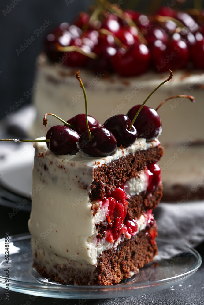 Plate with piece of tasty cherry cake on table