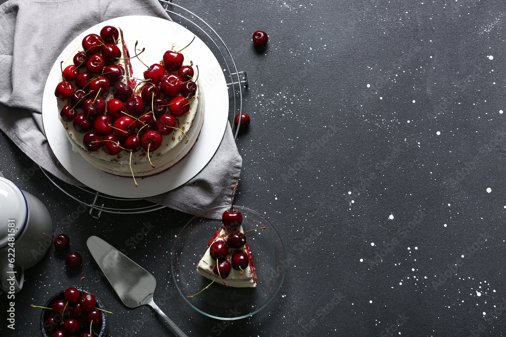 Plate and grid with tasty cherry cake on black background