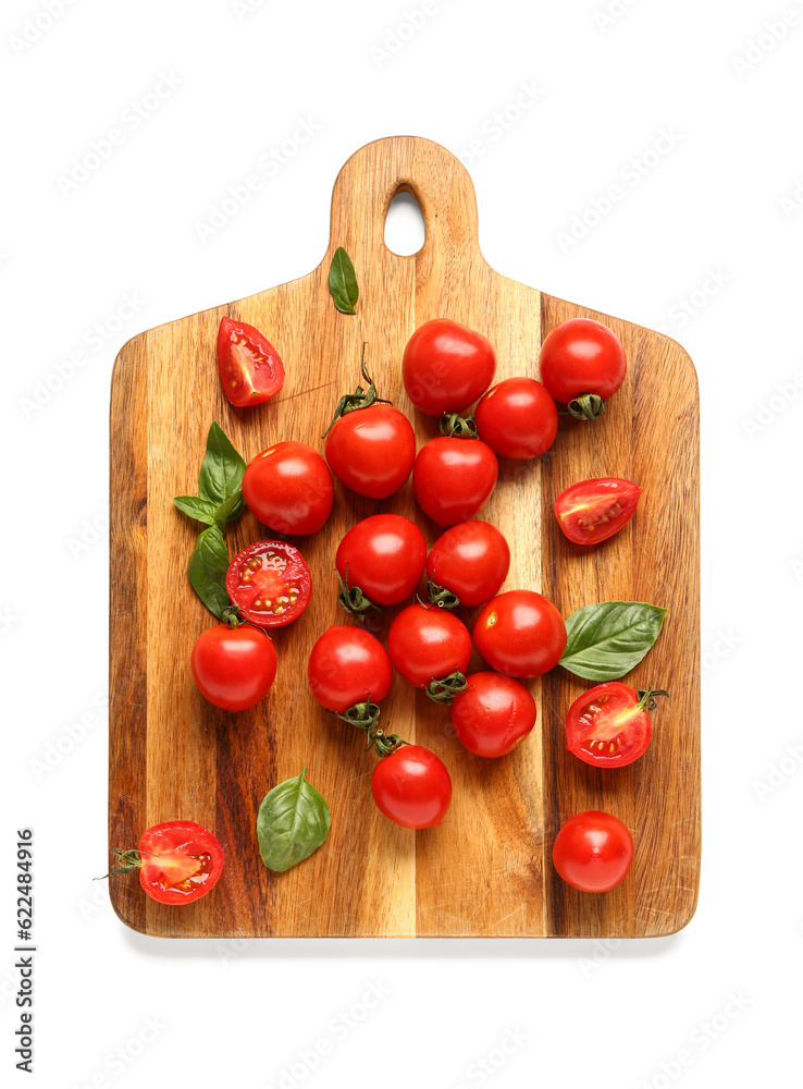 Wooden board with fresh cherry tomatoes and basil on white background