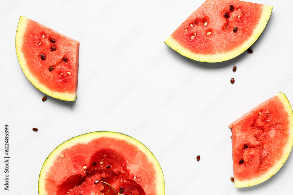 Half of fresh watermelon with pieces and seeds on white background