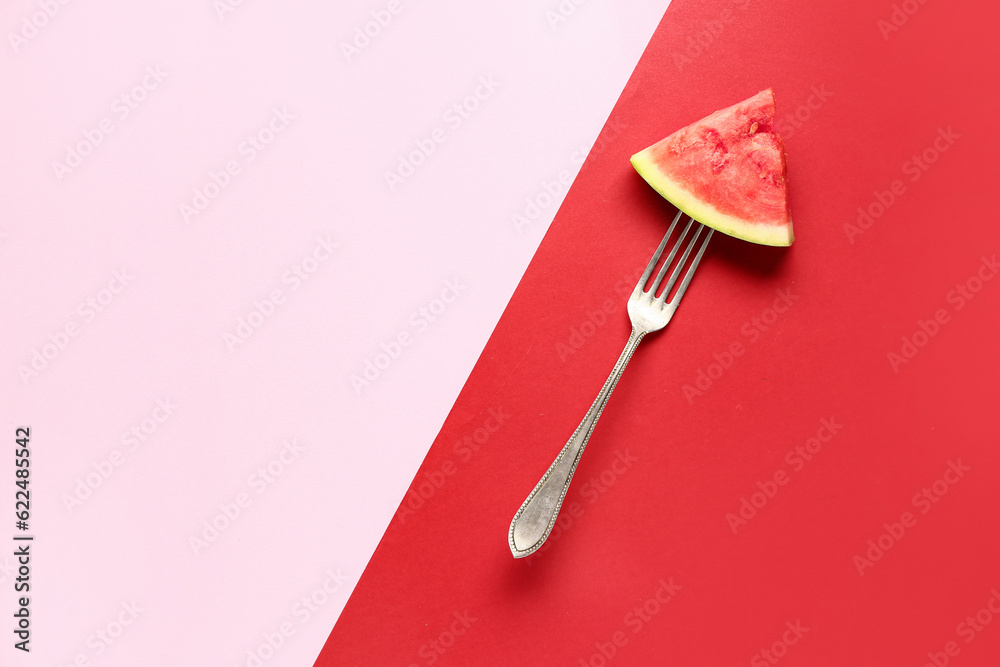 Fork with piece of fresh watermelon on colorful background