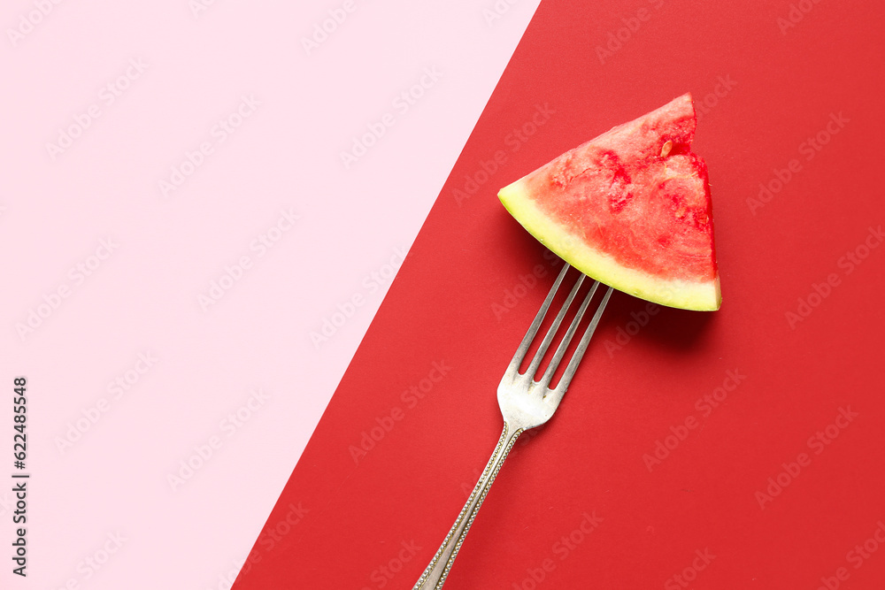 Fork with piece of fresh watermelon on colorful background