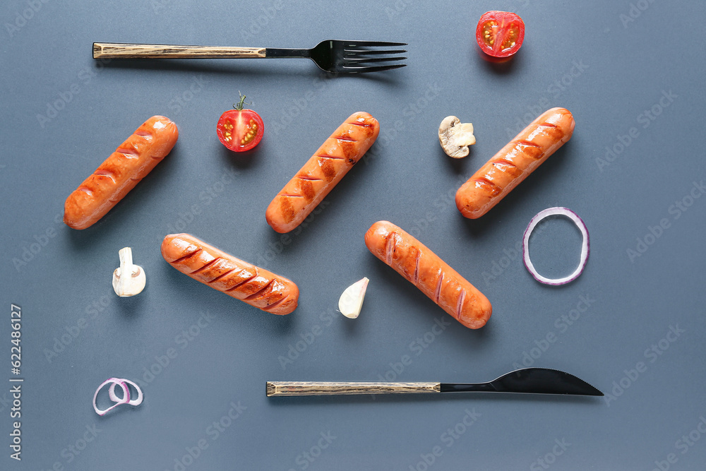 Tasty grilled sausages on grey background