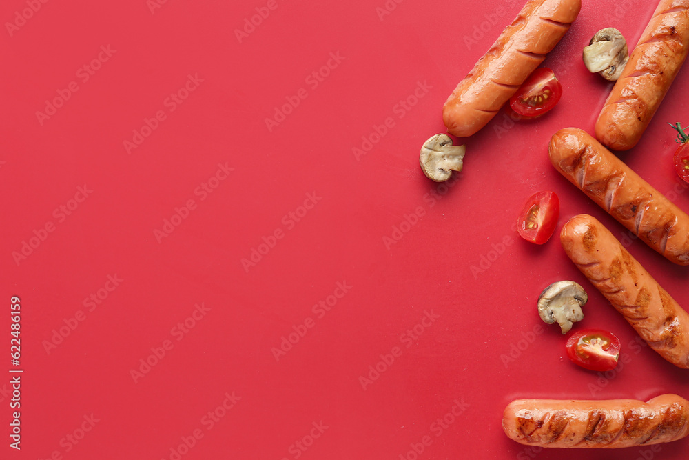 Tasty grilled sausages on red background