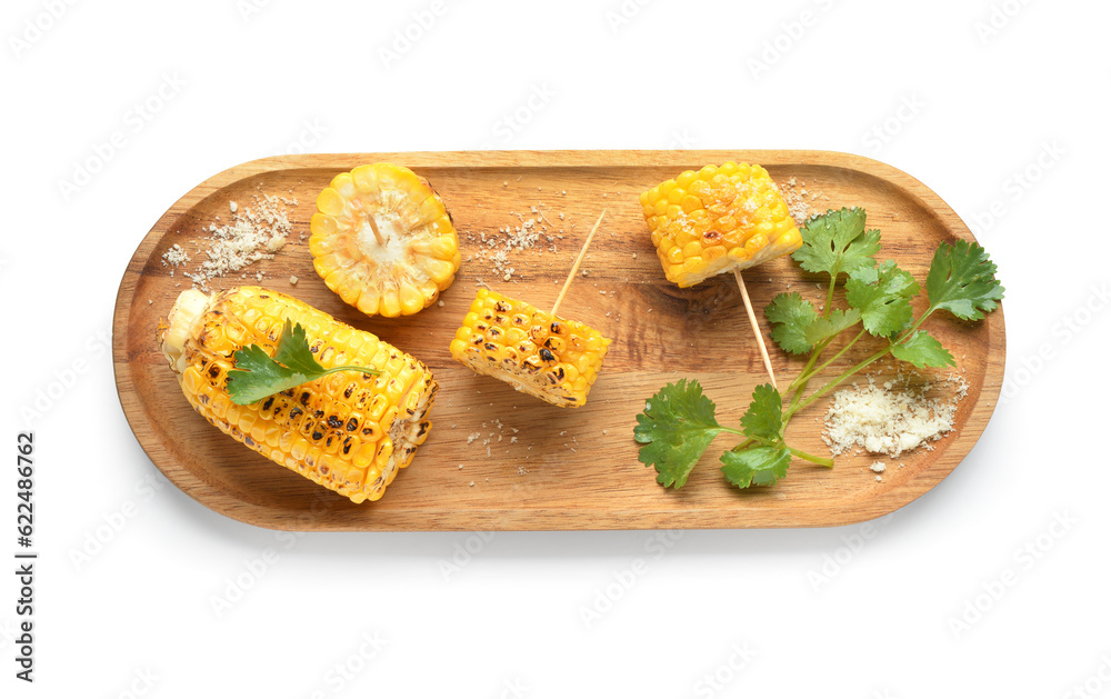 Wooden board with tasty grilled corn cobs and parsley on white background