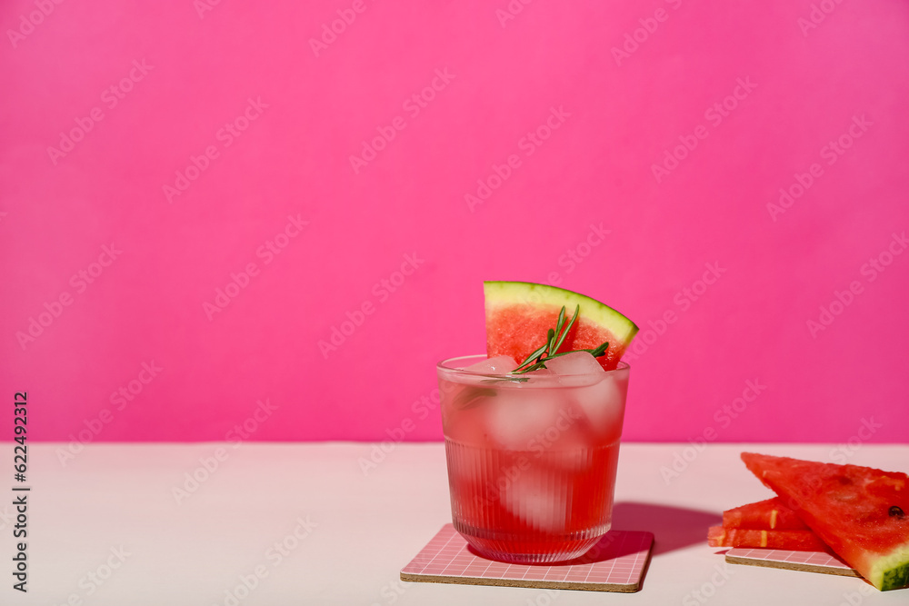 Glass of tasty watermelon cocktail on color background