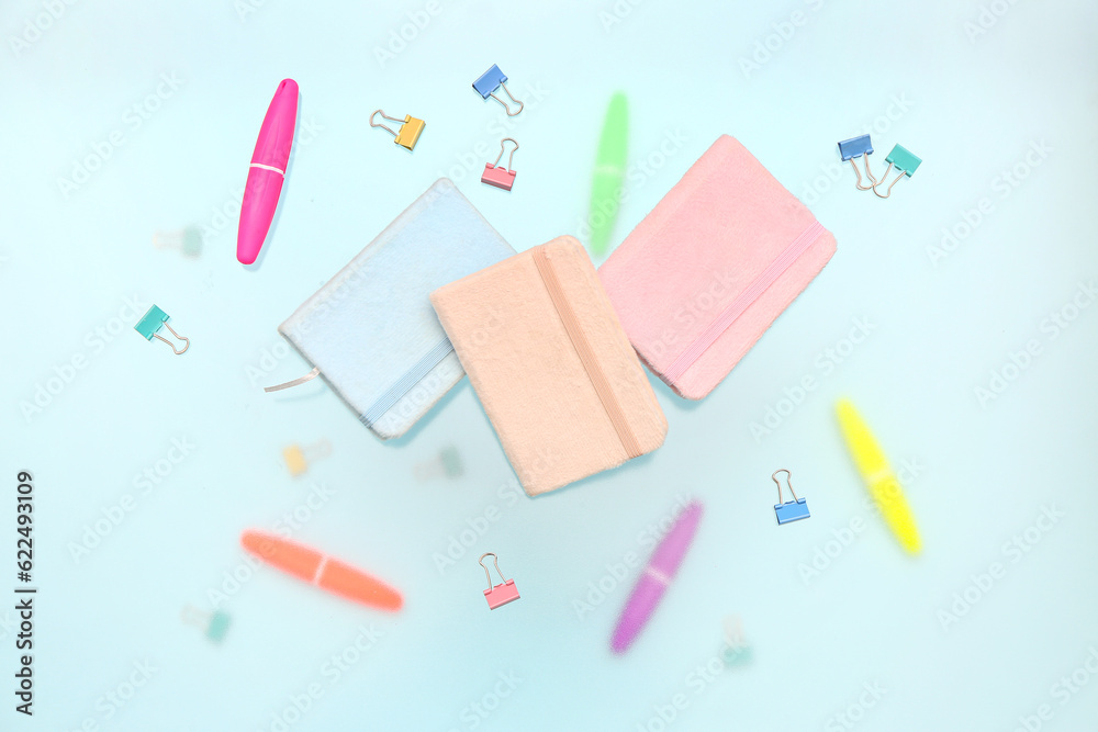 Notebooks with stationery on blue background