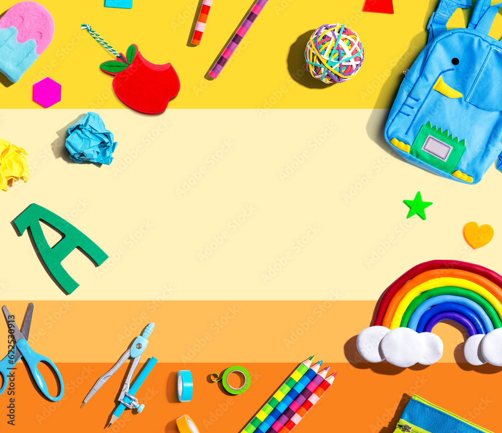 School supplies with a rainbow - overhead view - flat lay