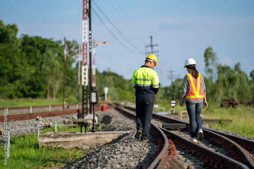 Architects and engineers wear safety suits and helmets to work. Walk to inspect the tracks to plan f