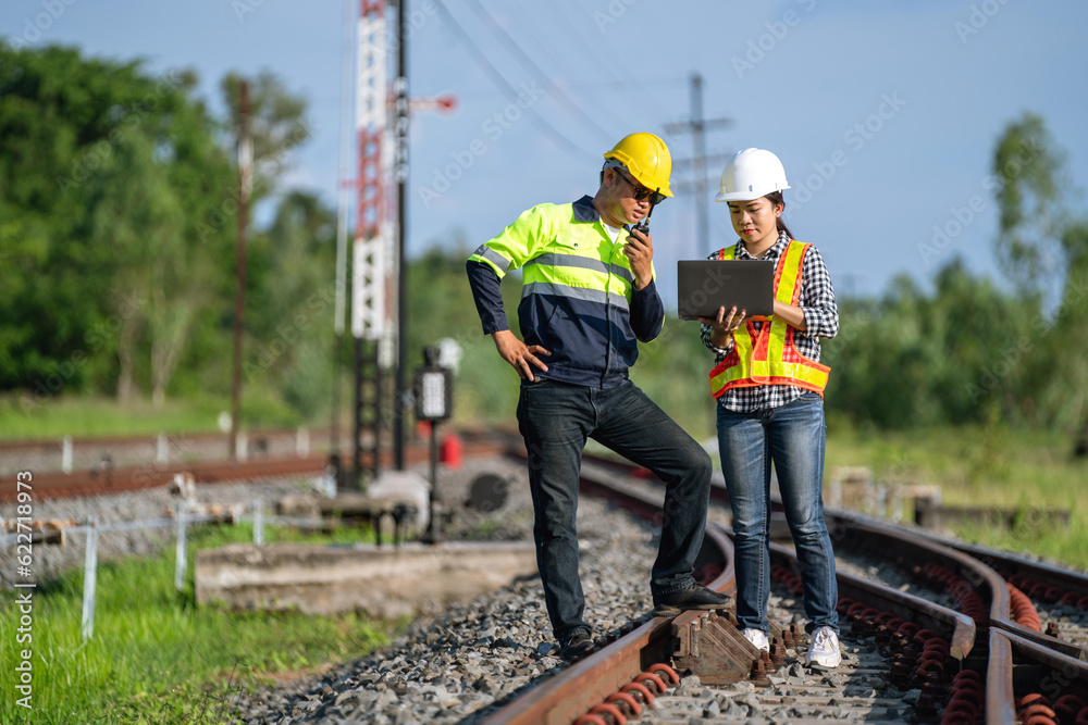 Architects and engineers wear safety suits and helmets to work. standing to inspect the tracks to pl