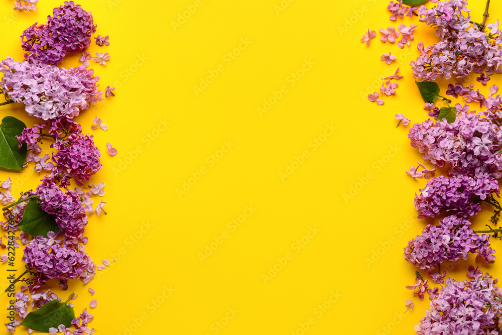 Beautiful lilac flowers on yellow background