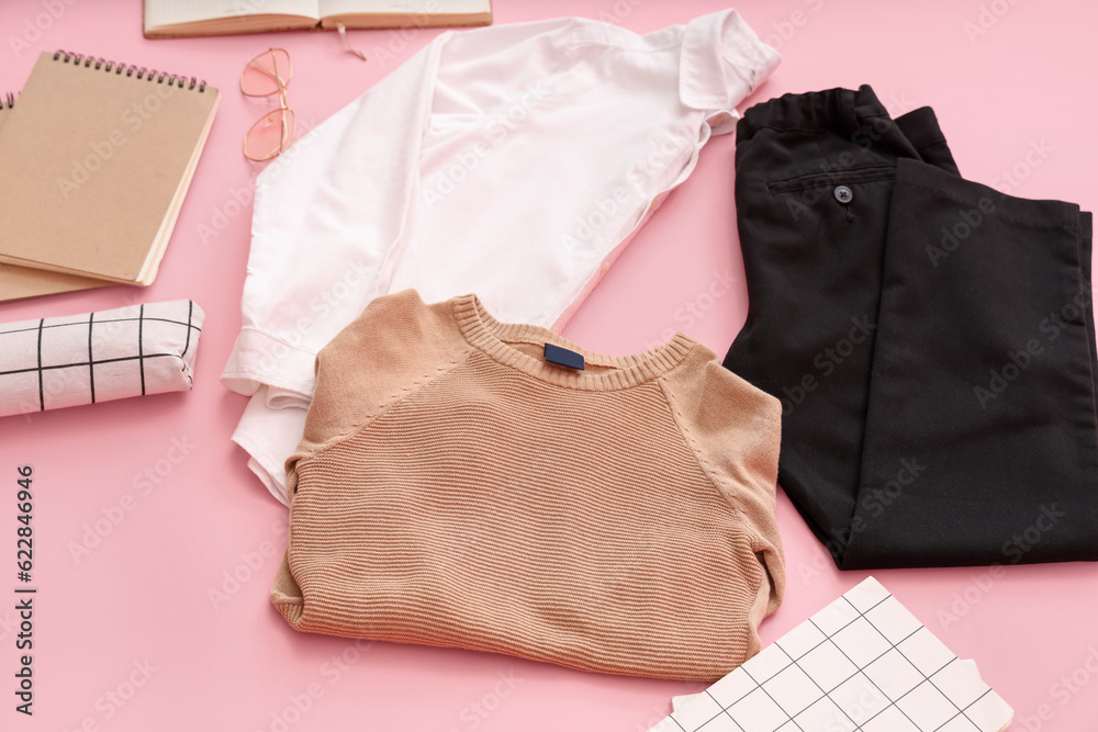 Composition with stylish school uniform and notebooks on pink background, closeup