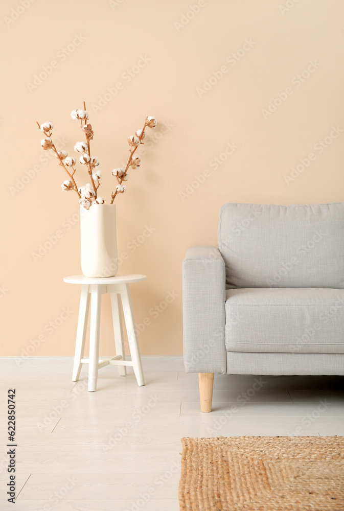 Interior of living room with sofa  and cotton branches