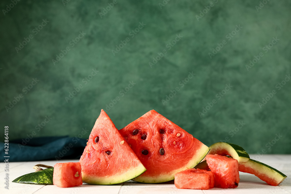 Pieces of fresh watermelon on white tile table