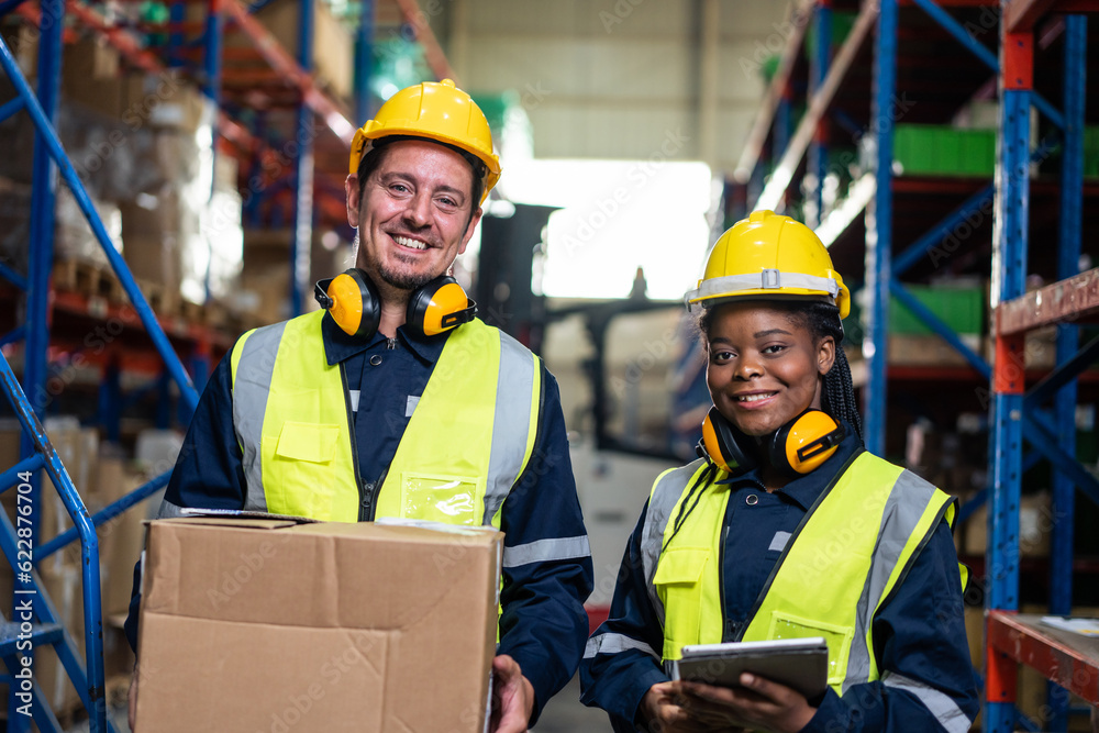 Portrait of industrial worker team work in manufacturing plant together. 