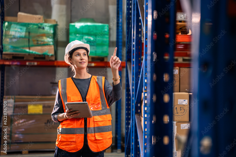 Caucasian young woman industrial worker working in manufacturing plant. 