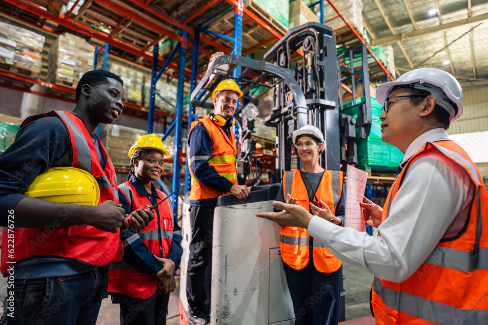 Group of man and woman industrial worker work in manufacturing plant. 