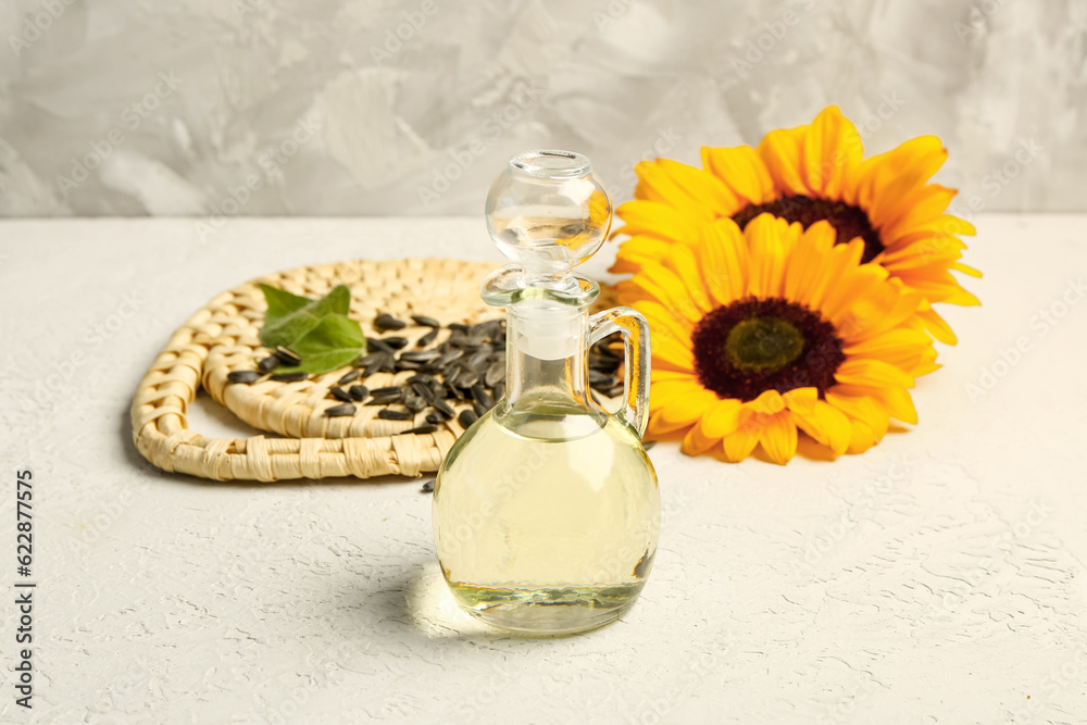 Decanter of sunflower oil on grey background